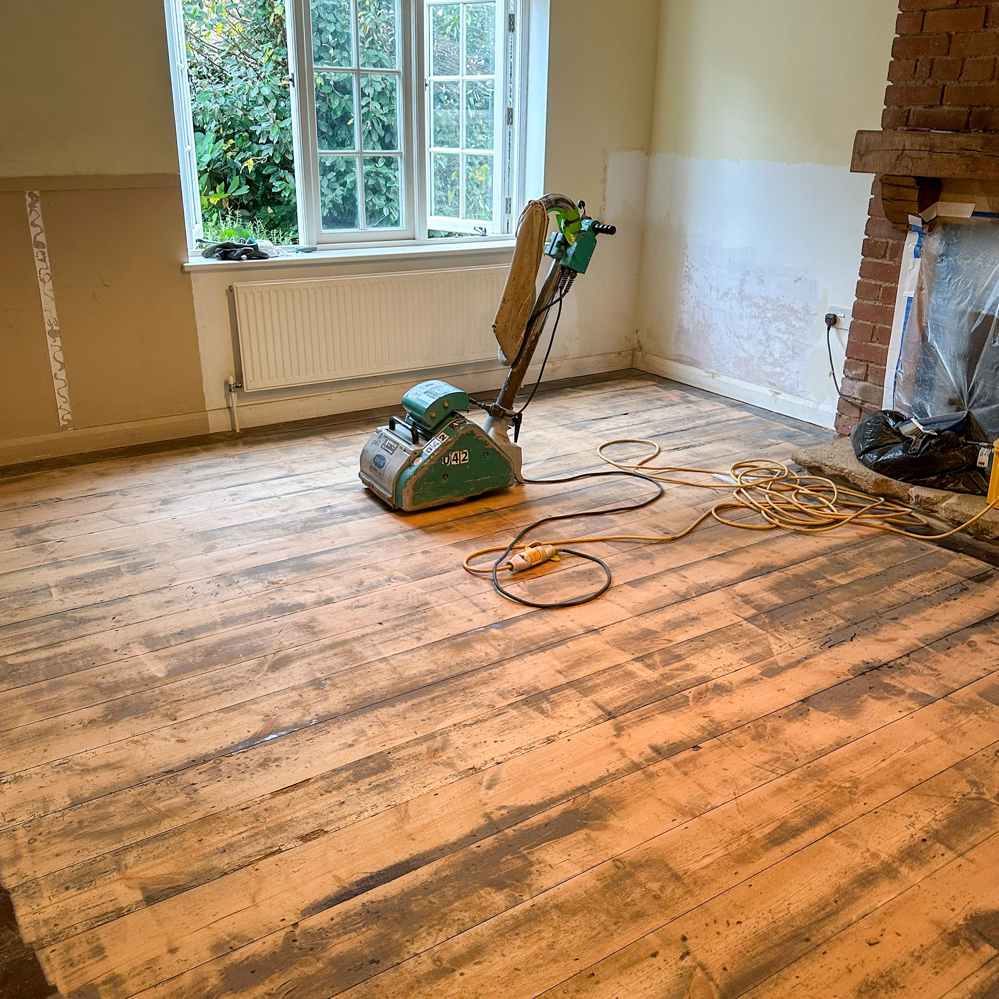 a floor partway through being sanded