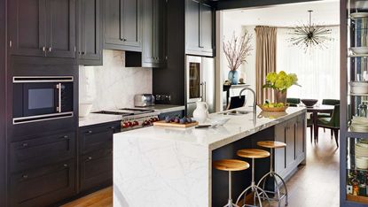kitchen with white island and black cabinetry