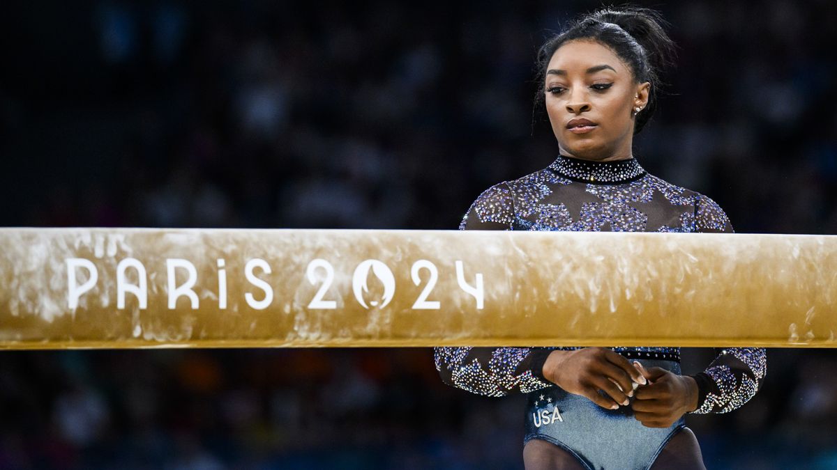 Simone Biles stands behind the balance beam at the 2024 Paris Olympics Games.