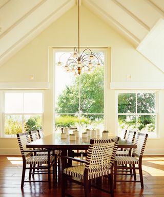 Chandelier hanging from the ceiling, over a dining table