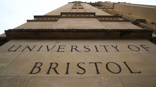 The words "UNIVERSITY OF BRISTOL" on the side of the Wills Memorial Building in Bristol, shot in extreme close-up from below.