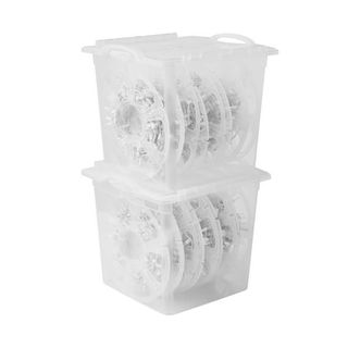 Two plastic see through boxes with lids stacked up. They have round white wheels inside that safely store lighting 