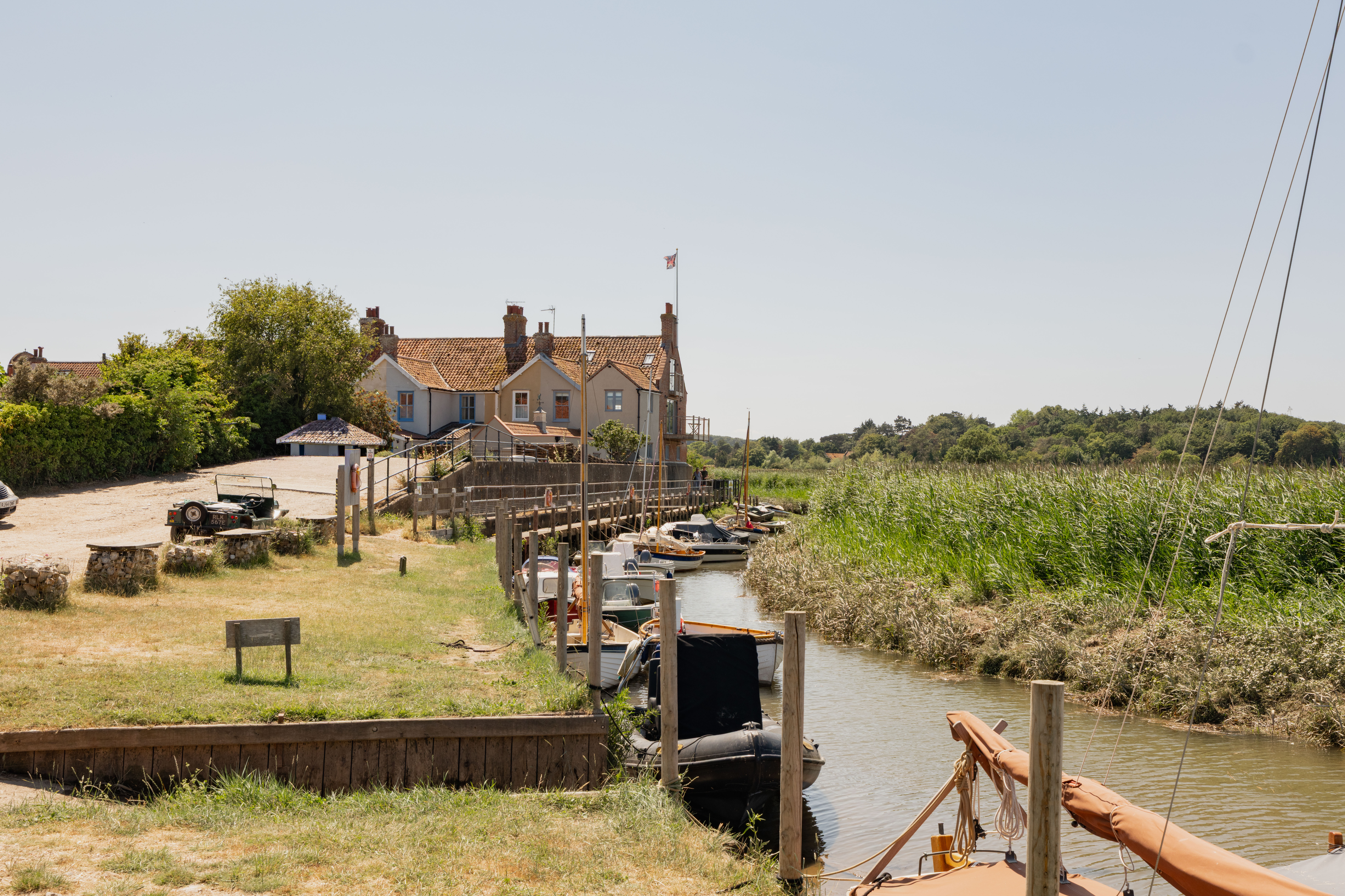 Cley Windmill. The mill is surrounded by reed beds and little rivers, and it is red brick with a white top. Inside, the rooms are luxurious but rustic, with lots of brick and exposed beams.