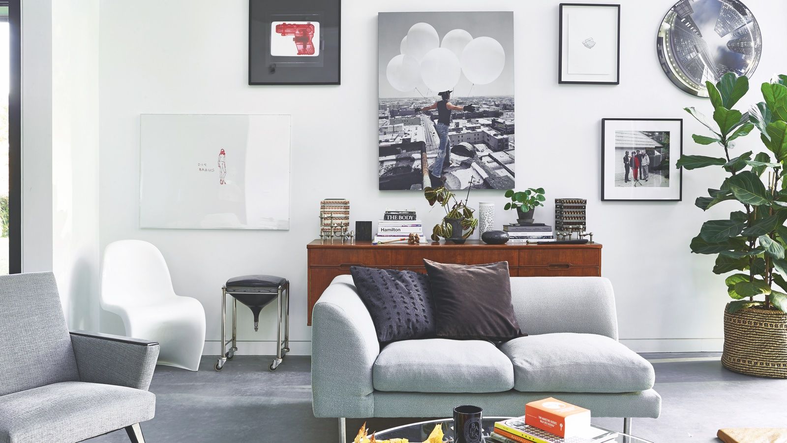 grey sofa in wihte living room of barn-style home