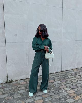 Aida wears her Stan Smiths with a green jumpsuit.
