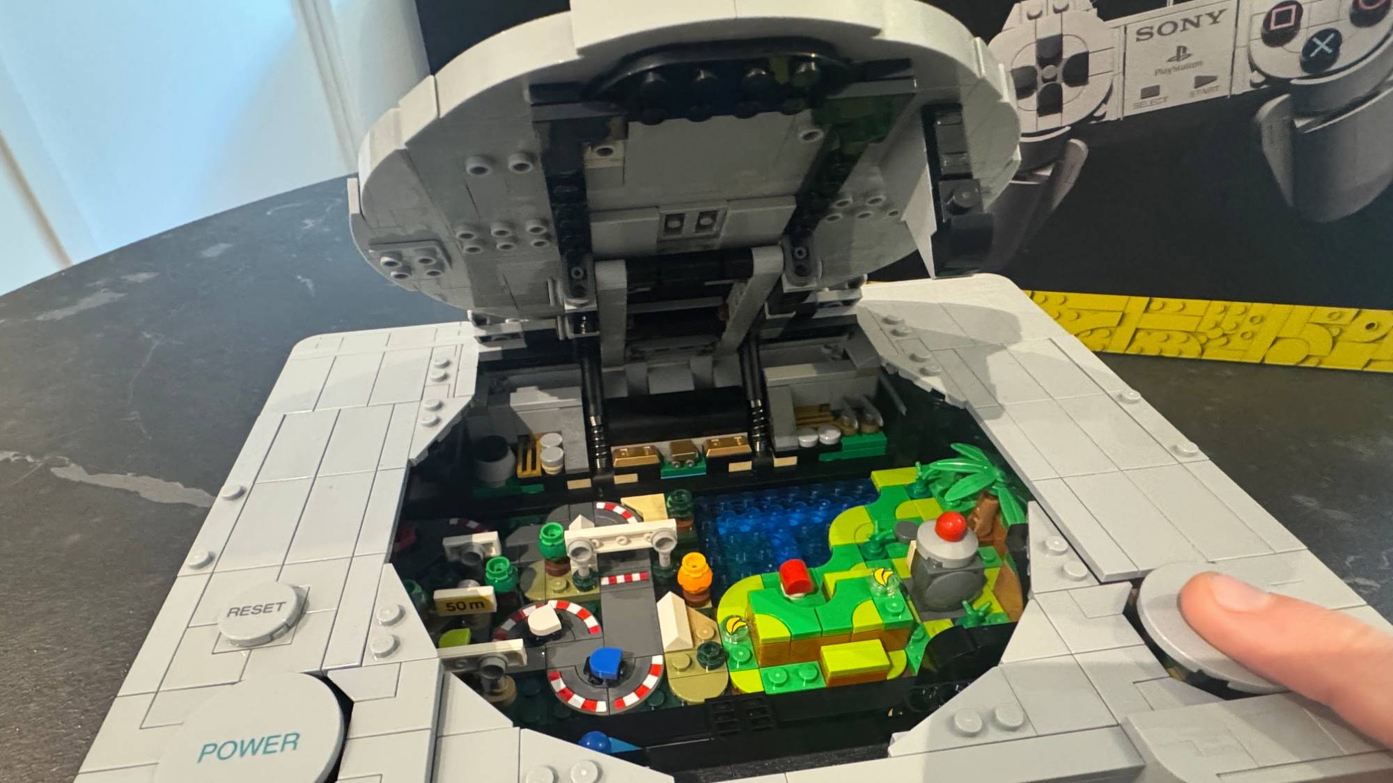 Lego PlayStation model on a table with the box in the background
