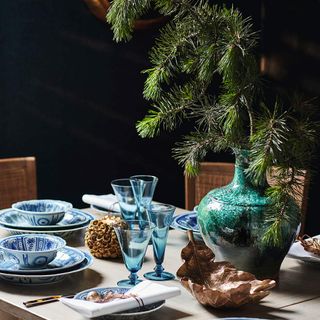 Dining table with fir in vase for christmas decorational centrepiece
