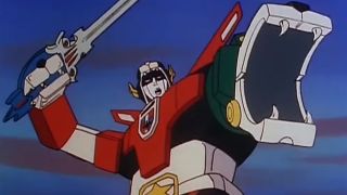 The Voltron robot holding his sword above his head with an outstretched lion arm growling. 