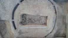 An aerial view of a burial containing a skeleton and grave goods.