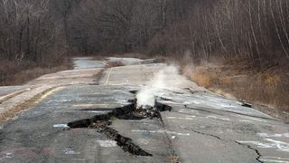 An empty road in Centralia, Pennsylvania, leaks smoke from the underground fire.