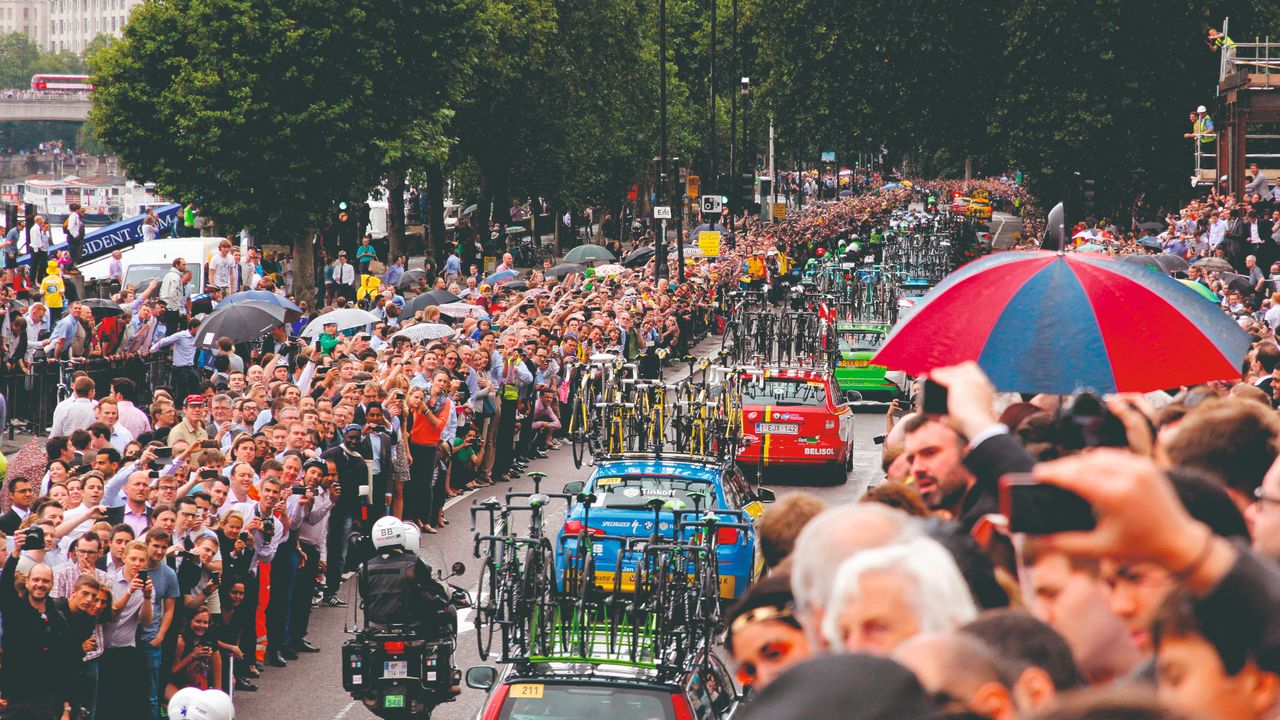 Tour de France support team vehicles emerging from Blackfriars underpass in front of huge crowds