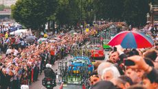 Tour de France support team vehicles emerging from Blackfriars underpass in front of huge crowds