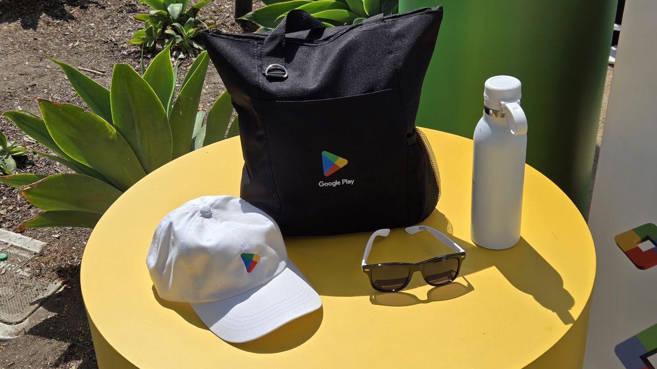 Google Play swag, including a bag, hat, sunglasses, and water bottle