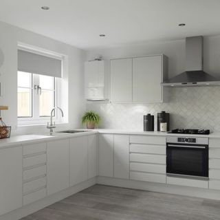 A white Alpha Boiler in a all white kitchen on the wall