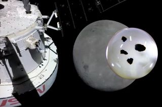 NASA's Artemis I Orion spacecraft heads for a close flyby of the moon as seen in this "selfie" taken by a camera mounted on one of the capsule's solar array wings on Monday, Nov. 21, 2022. Four small pieces of the moon collected by the Apollo 11 mission were on board the Orion for the journey.