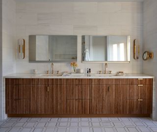 Bathroom with wooden cabinets and marble floors