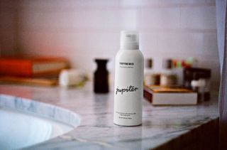 Jupiter dandruff and scalp care in white bottle on kitchen counter