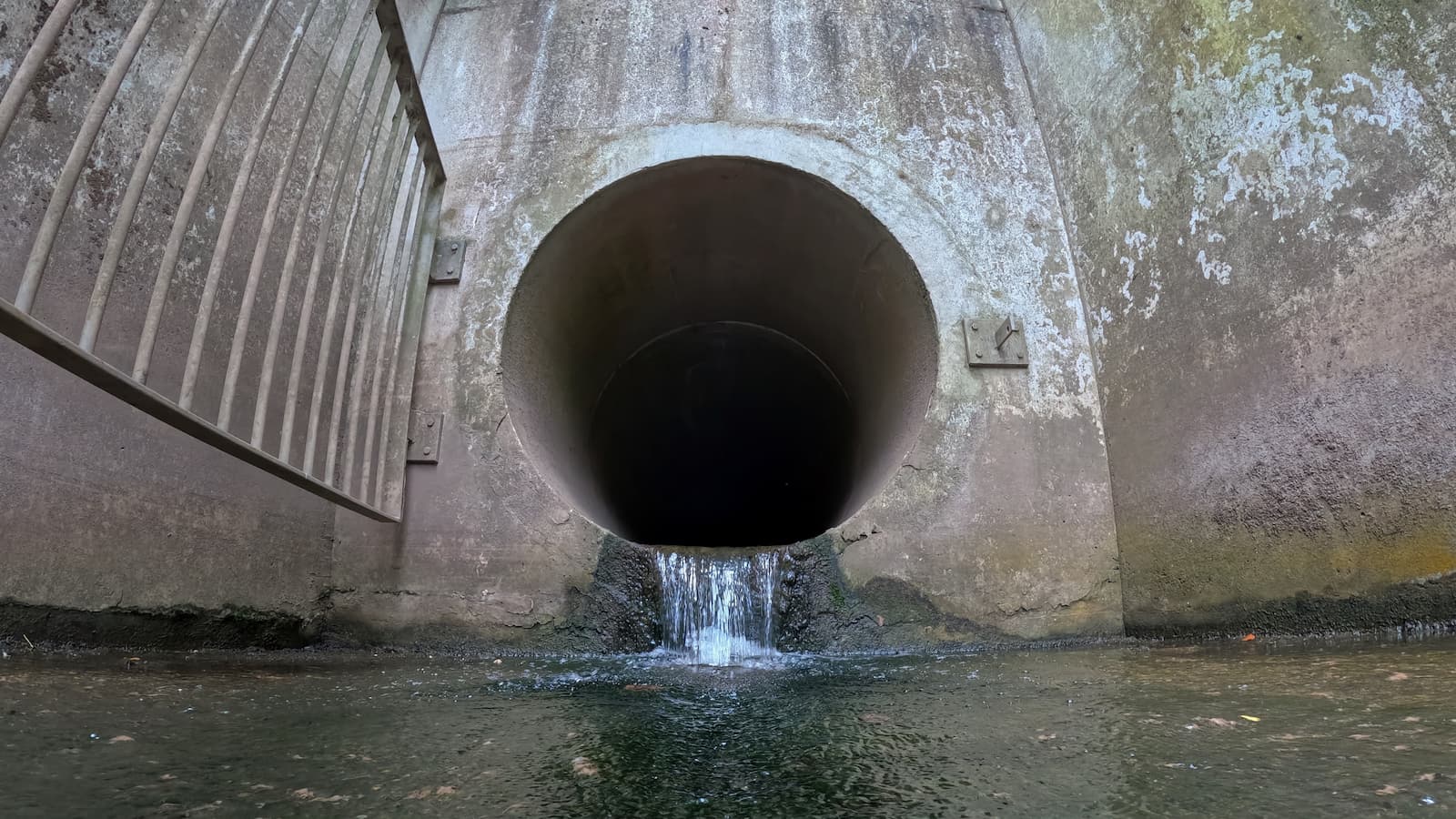 Water emerges from a pipe outlet from the United Utilities owned Northwich Water Treatment Works into the River Weaver on July 22, 2025 in Northwich, England