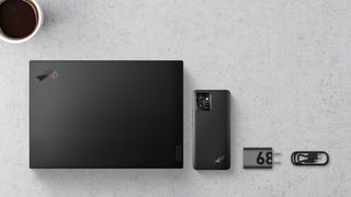 Lenovo ThinkPhone by Motorola next to the Lenovo ThinkPad X1 Carbon