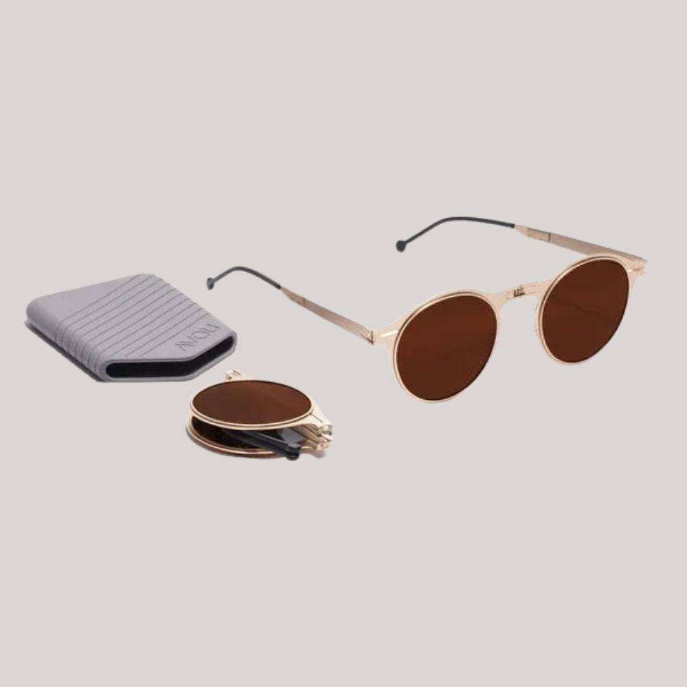 ROAV Balto Gold Brown Sunglasses against pale beige background.