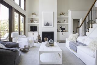 Monochrome living room with two armchairs and a white sofa