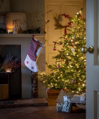 A view of a Christmas tree from doorway with stocking