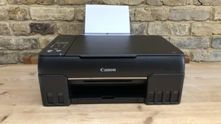 Canon PIXMA G620/G650 with a sheet of paper preparing to print