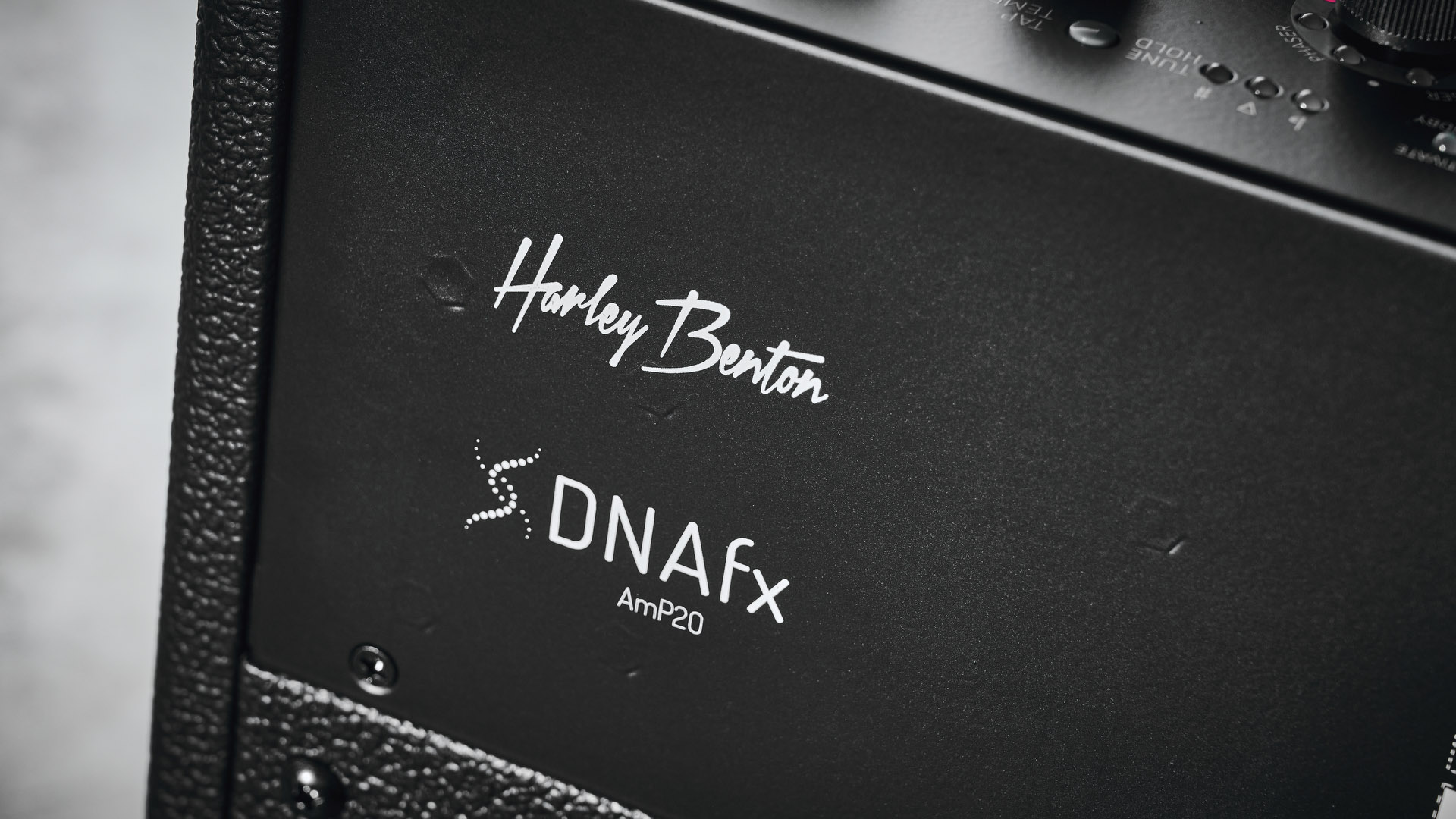 Harley Benton DNAFX AmP20: the compact 1/8&quot; modelling combo is finished in black and photographed in close-up and against a slate floor