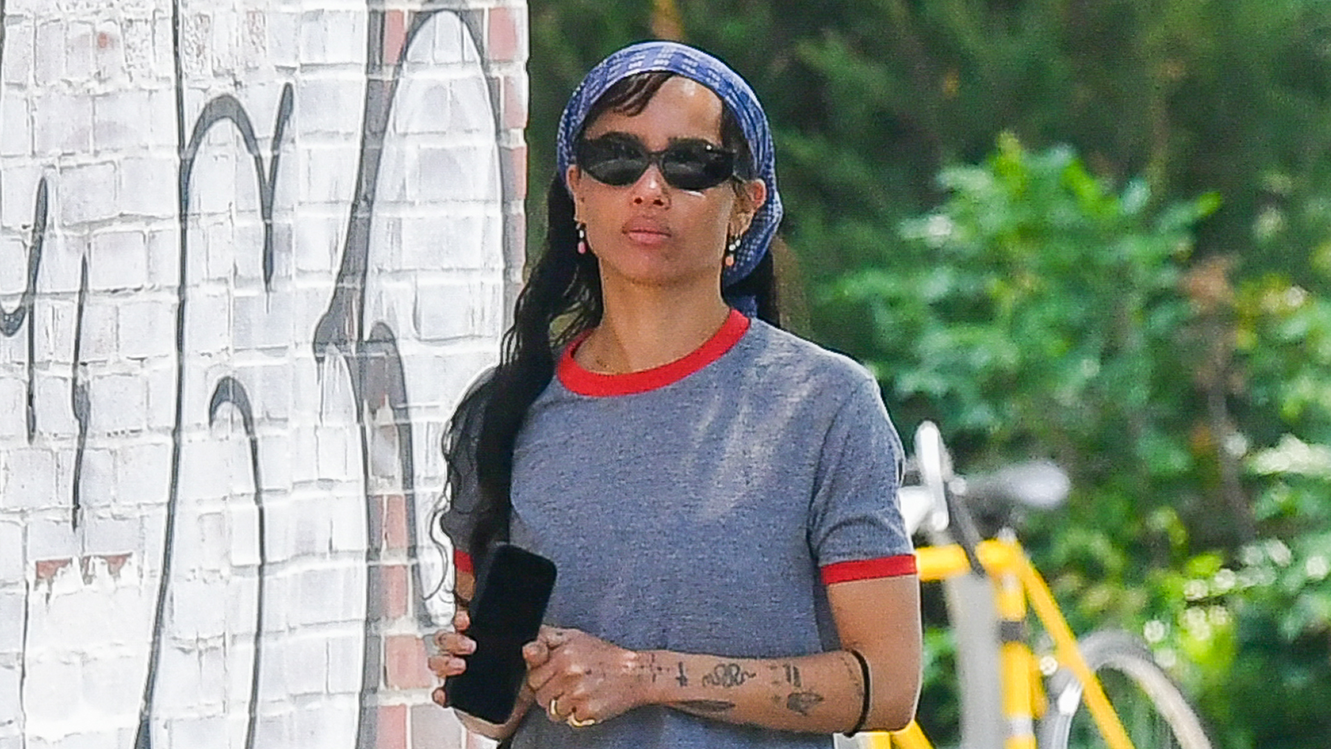 Zoë Kravitz coordinates her The Row flip flops to her ringer T-shirt.
