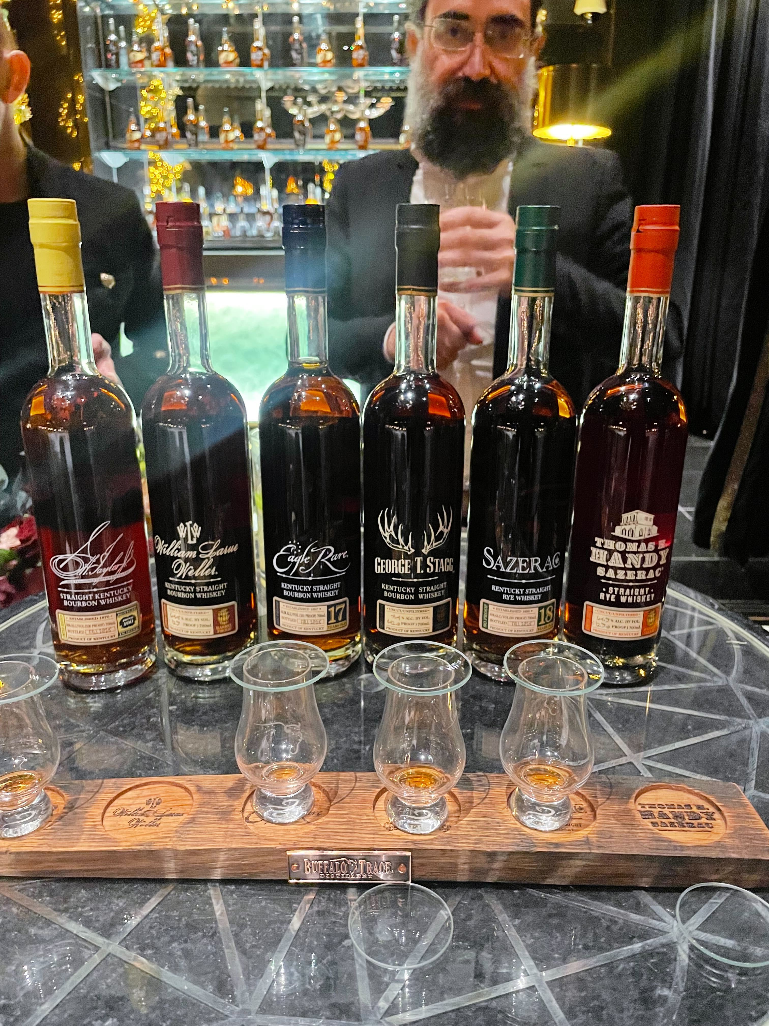 an image of the bottles in the collection behind the tasting glasses