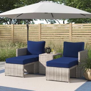 Two navy blue and wicker outdoor lounge chairs