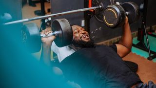 Man performs incline dumbbell press