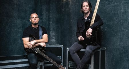 Alter Bridge's Mark Tremonti [left] and Myles Kennedy sit on flight cases as they're photographed with their PRS signature guitars.