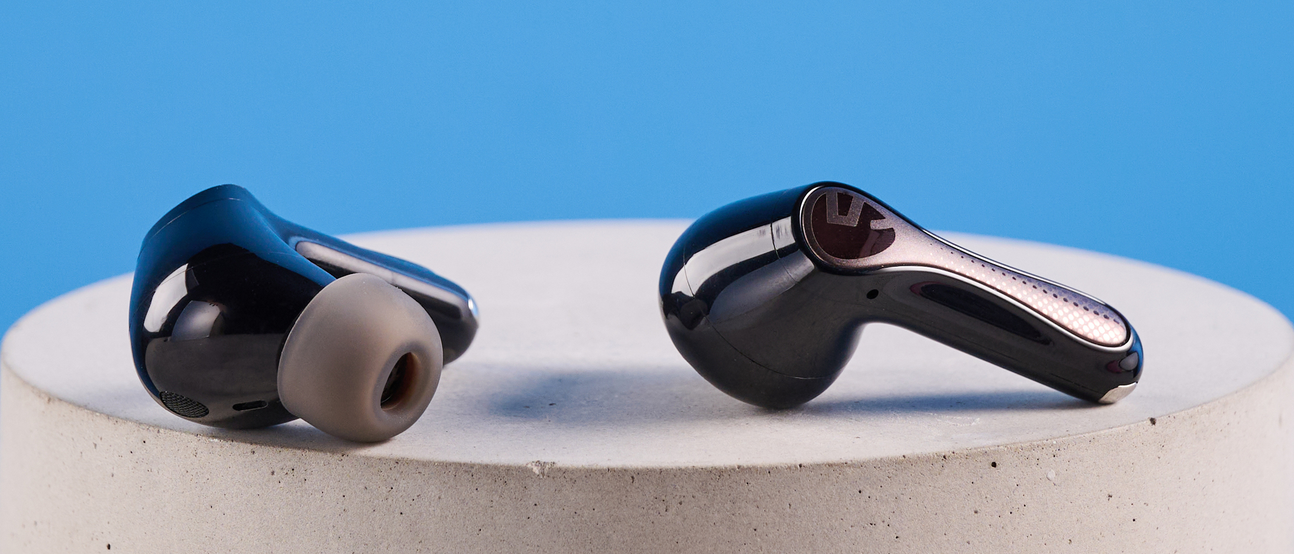the soundpeats air5 pro earbuds in black and bronze with a black charging case and ear tips