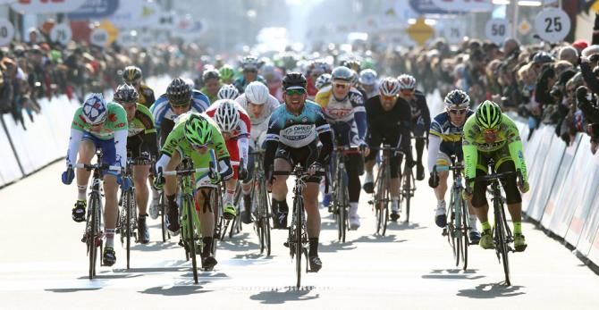 Mark Cavendish starts to celebrate after winning stage 2 in Koksijde.