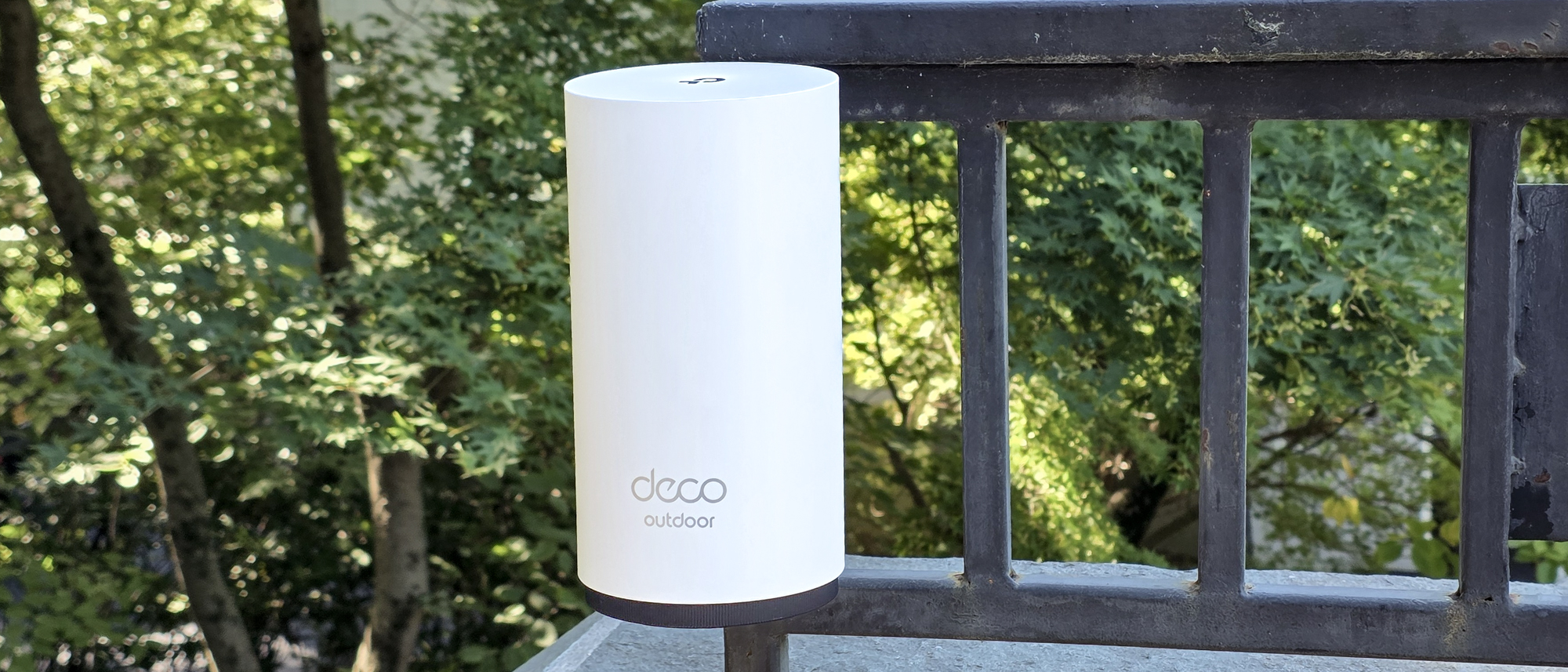 TP-Link Deco BE65-Outdoor mounted on a railing