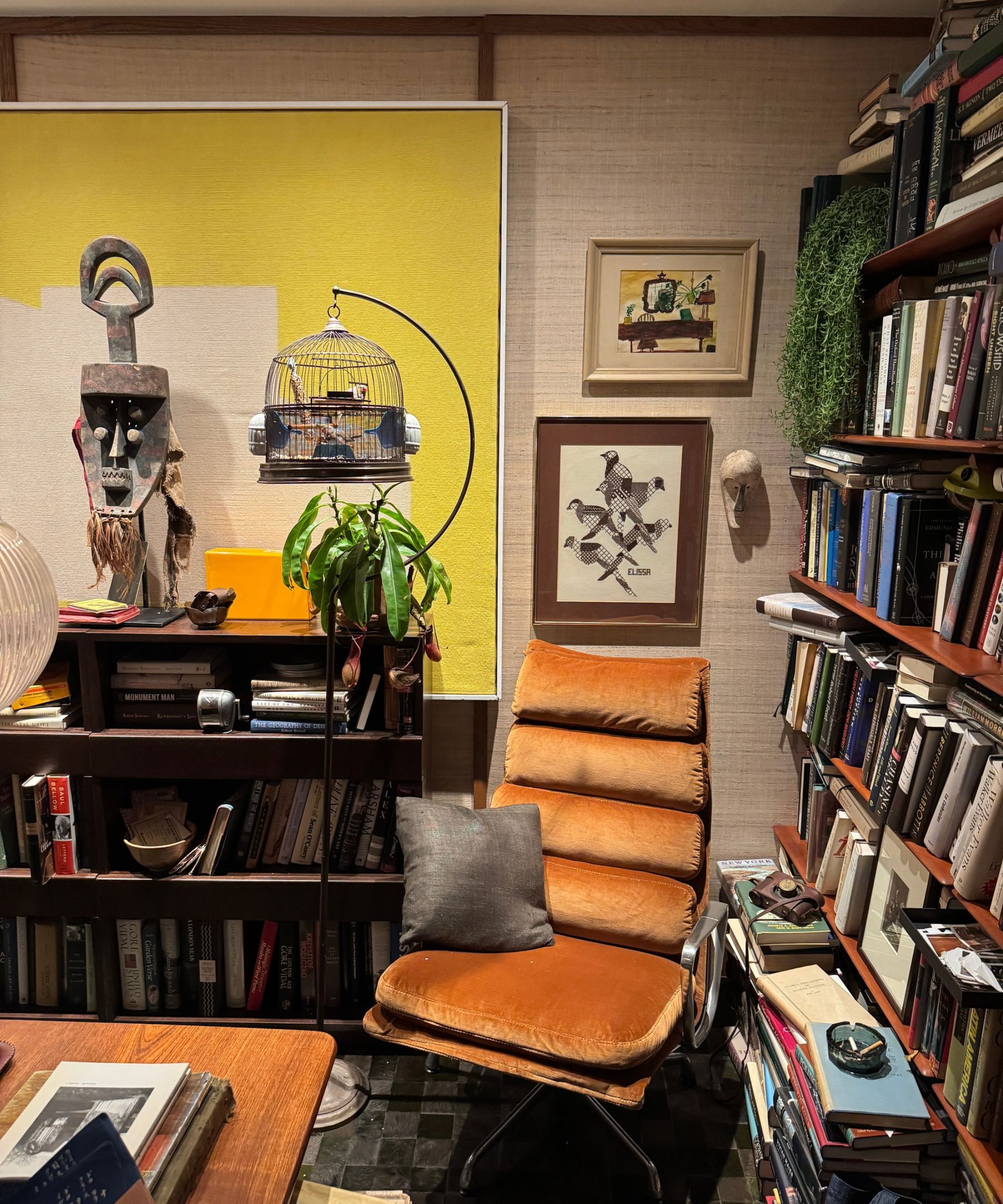Home study in Kips Bay New York - editors office with chair, books, pictures and bird cage