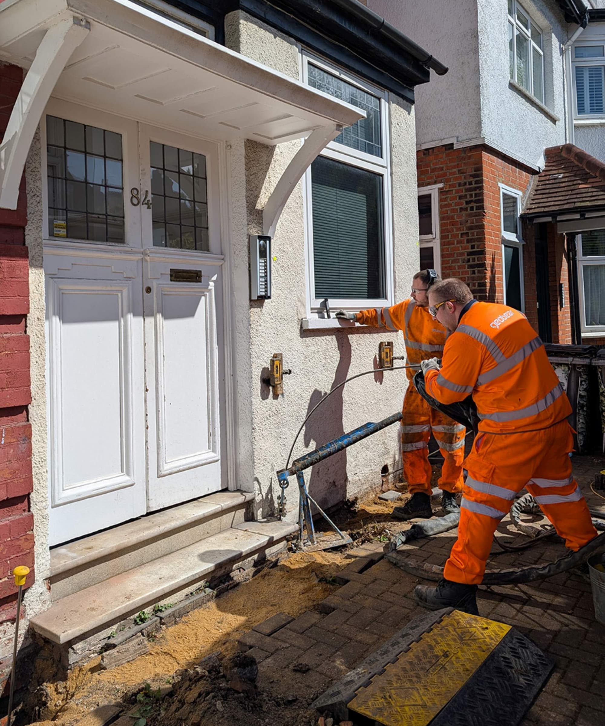 A couple of repair workers working on a home with subsidence