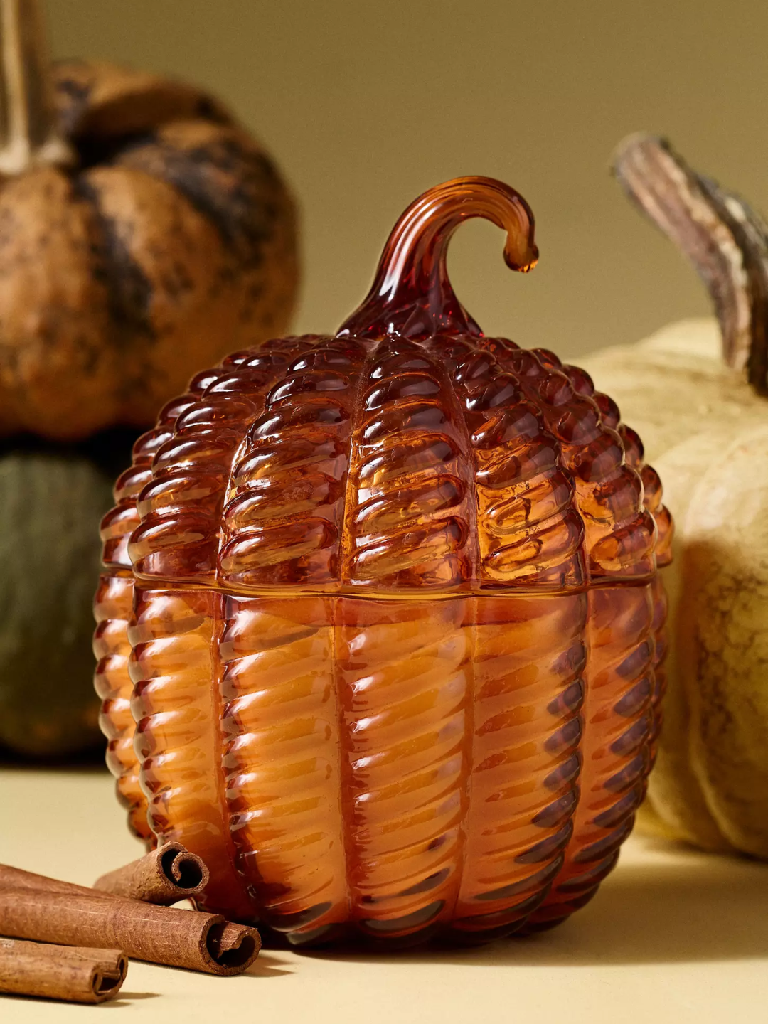 An orange textured glass pumpkin and sweet vanilla candle