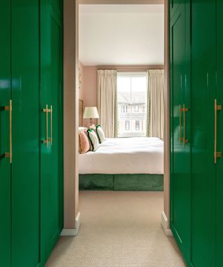 Bedroom with green gloss painted cupboards