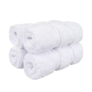Four white rolled towels
