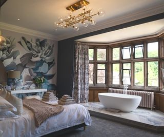 freestanding bath in large bay window area with tiled marble platform