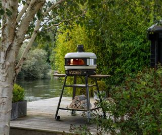 wood fired white pizza oven on a decked patio