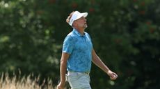 Ian Poulter tips his head back in frustration while walking along at LIV Golf UK on day one