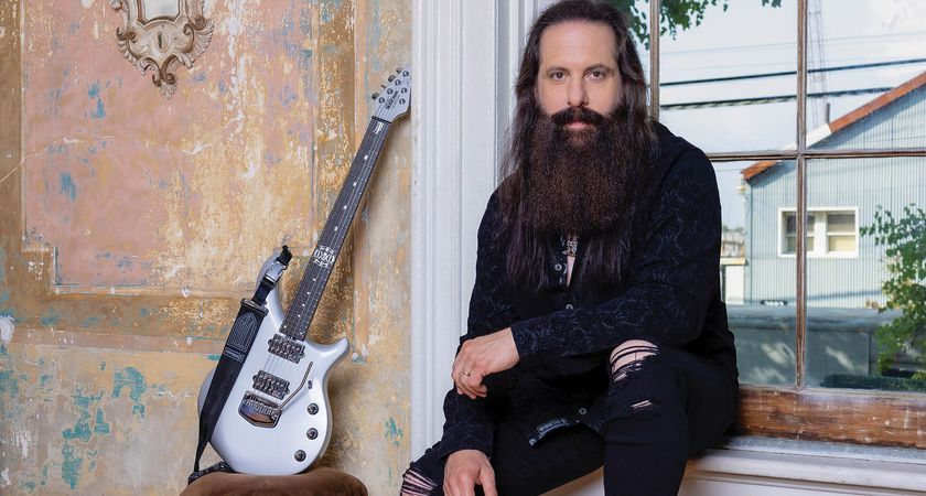 Dream Theater&#039;s John Petrucci sits on the windowsill with his silver Ernie Ball Muisc Man Majesty beside him