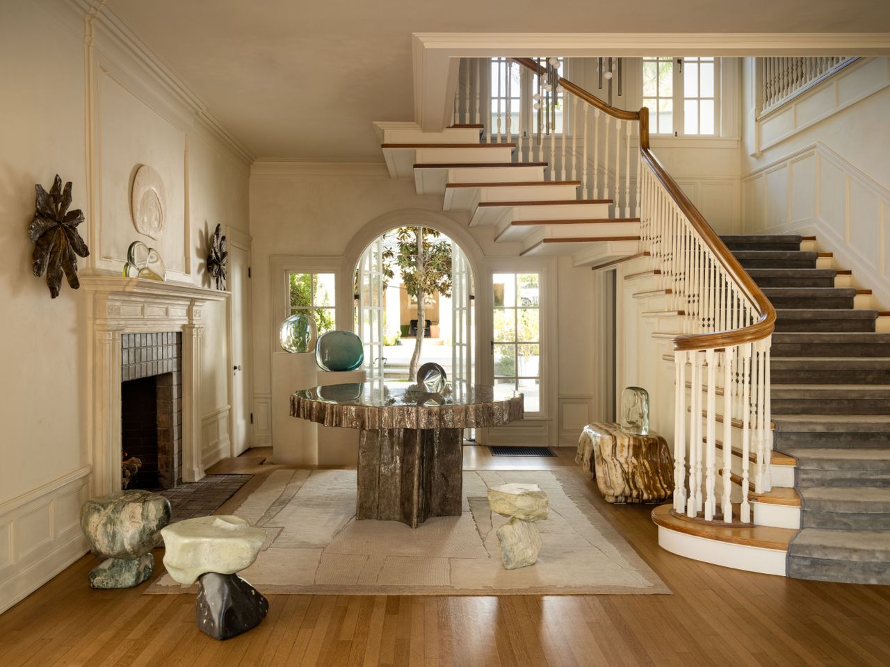 A Californian home with wooden floors is decorated in spectacular, sculptural ceramic stools, a table, and other artworks.