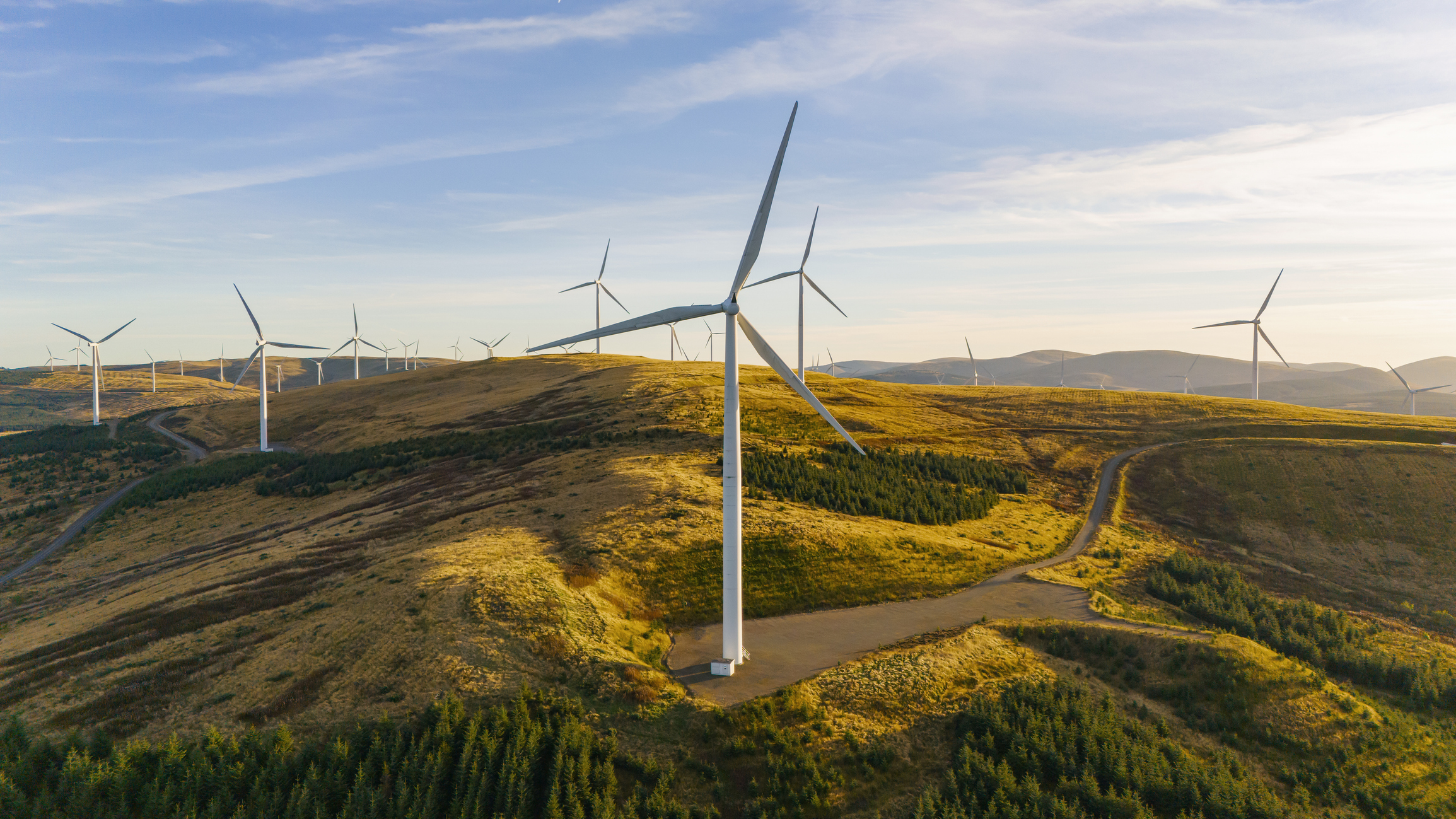 Drone/aerial view of a wind farm on a hilltop in Scotland