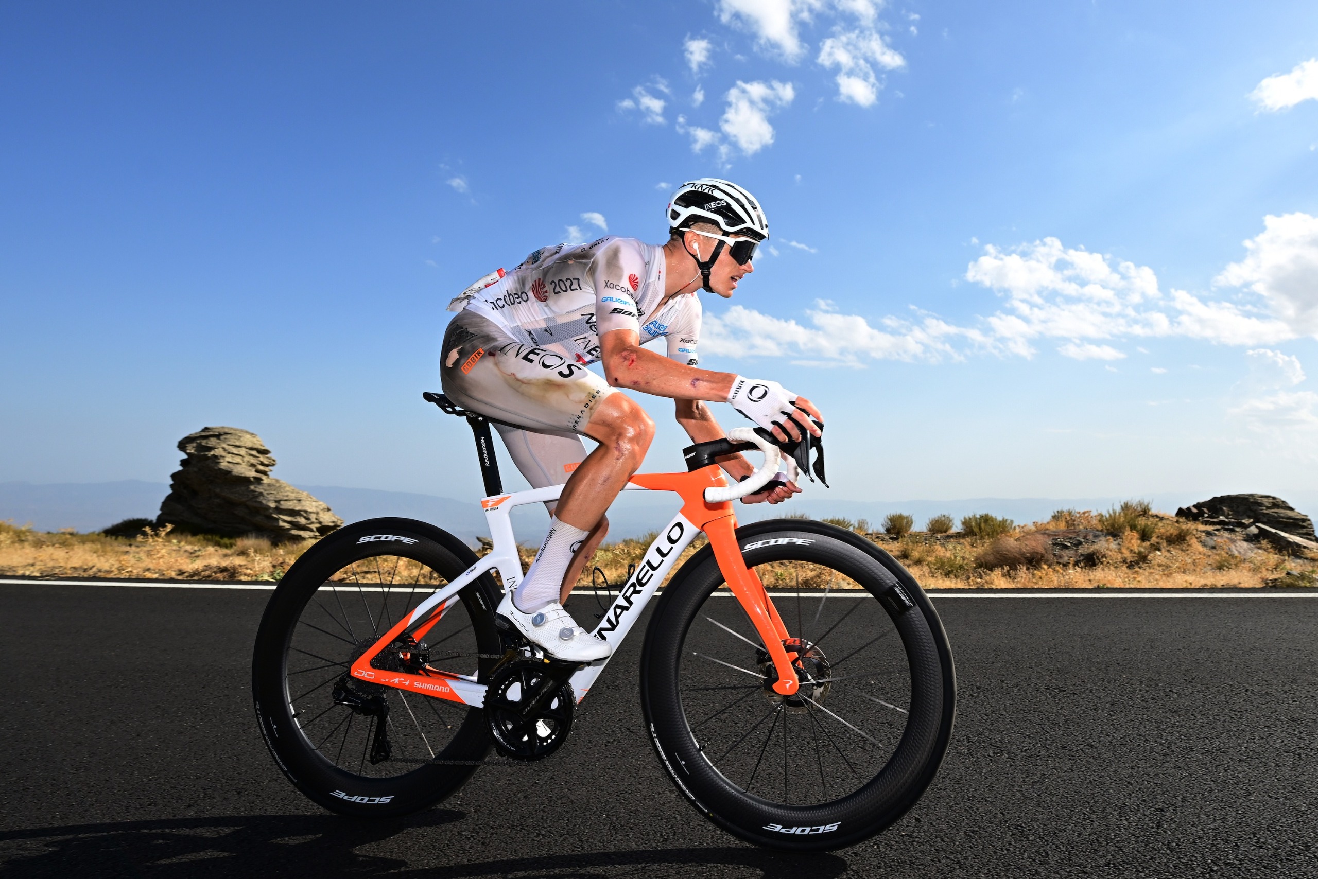 Oscar Onley rides in the white jersey
