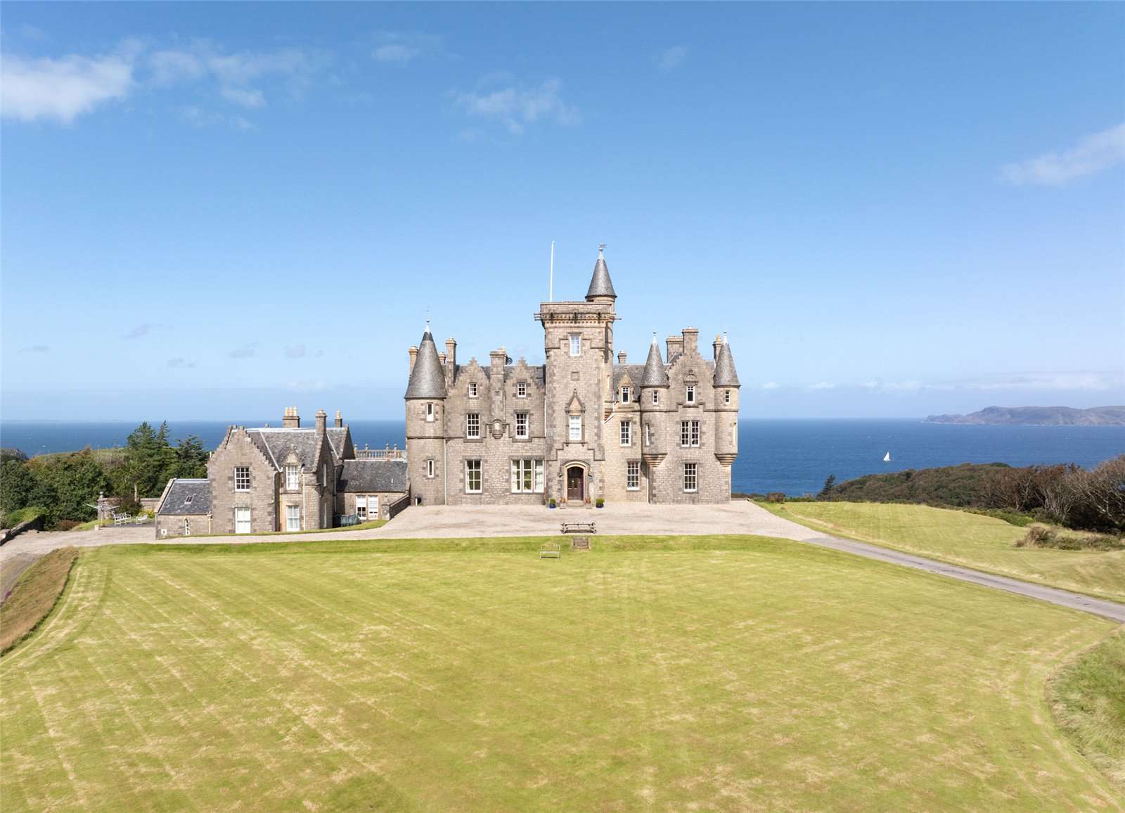 A view of Glengorm castle, with the sea behind