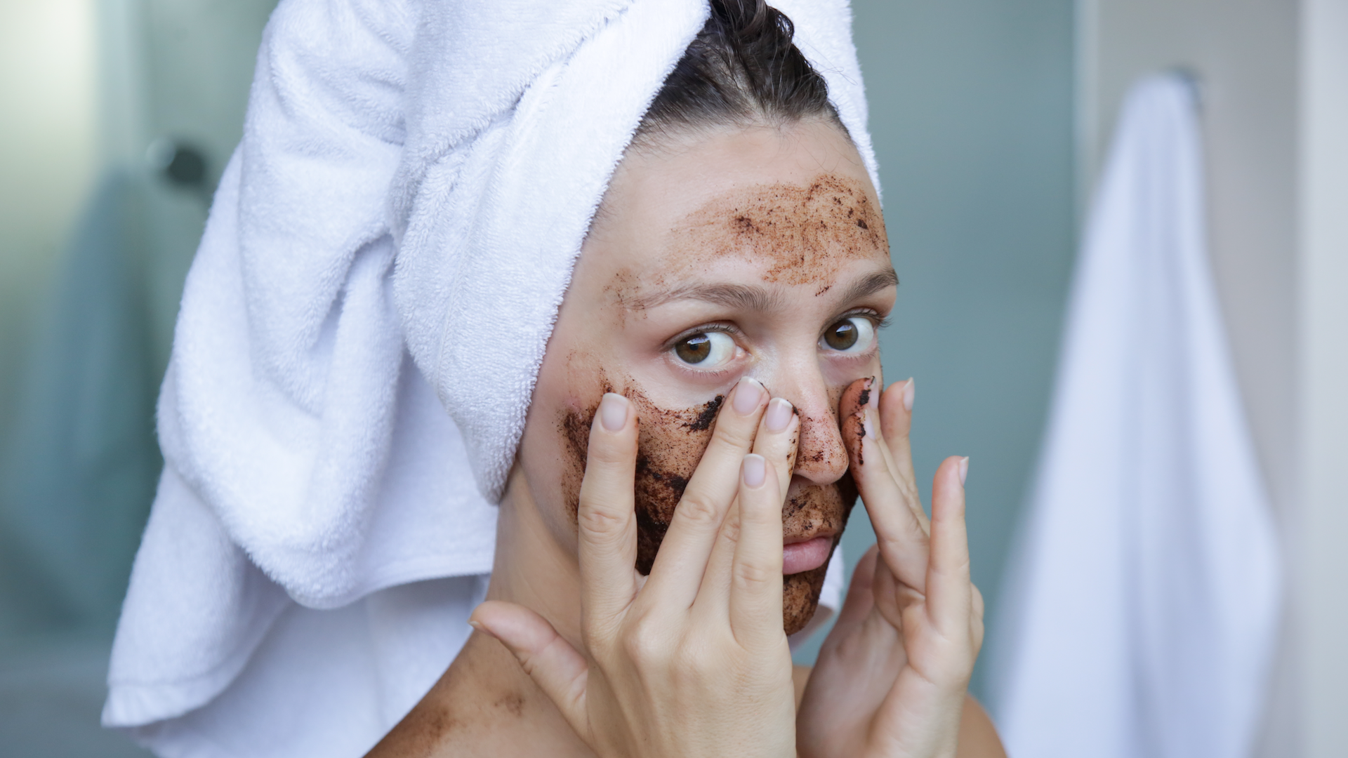 Woman exfoliating her face with scrub